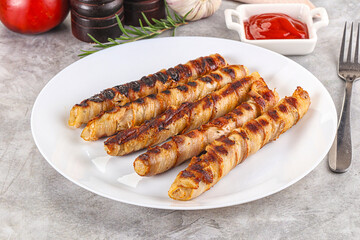 Grilled meat sausages wrapped bacon