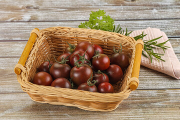 Obraz premium Juicy ripe black cherry tomato