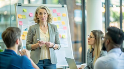 Portrait middle aged Woman leading a creative brainstorming meeting in a tech company office