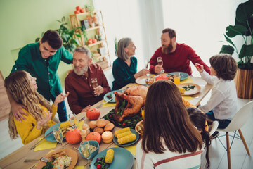 Photo of charming happy big family celebrating thanksgiving day people gathering together indoors room home