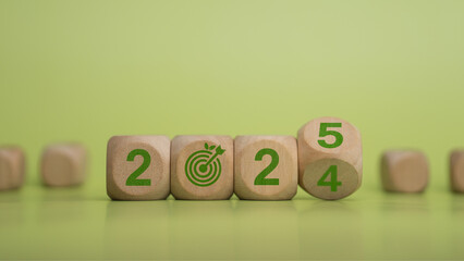 Green letter numbers on wooden blocks transition from 2024 to 2025. Environmental, social and governance concepts ESG, sustainable corporate development, long-term sustainable global environment.