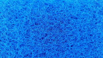 Texture detail of a rough blue dishwashing sponge