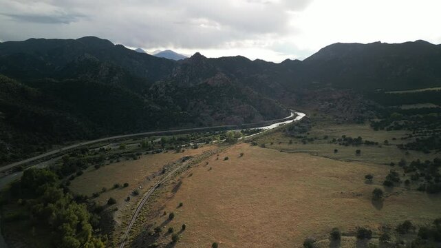 Aerial above Arkansas River near Canon City Colorado in summer along traintrack