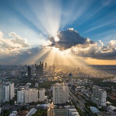 Wide Angle Sunset Over Big City: Sun Rays Streaming Through Clouds