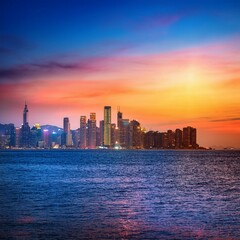 Naklejka premium Vibrant Cityscape: Captured from the Sea with Radiant Colors and Bright Lights