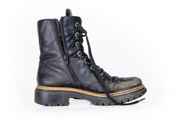 One black worn ankle leather combat boot with thick, sturdy sole and laces. Single vintage military style shoe. Studio light. Isolated on white background. Empty copy space. Clipping path