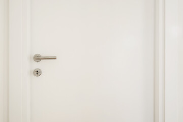 White interior door with metallic handle