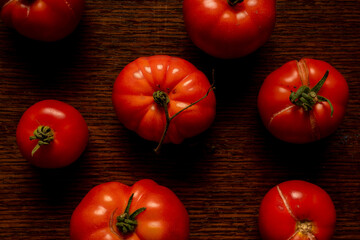 Homegrown organic ripe tomatoes on wooden worktop