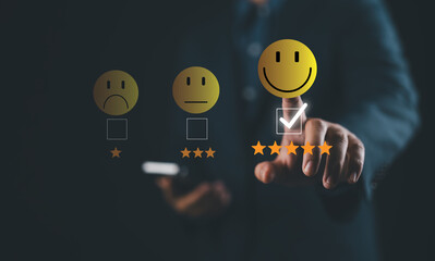 Businessman using smartphone and pushing smile button for the best evaluation , customer...