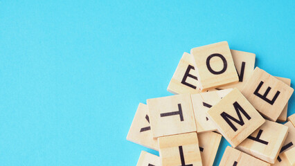 Wooden letter cubes isolated on blue background