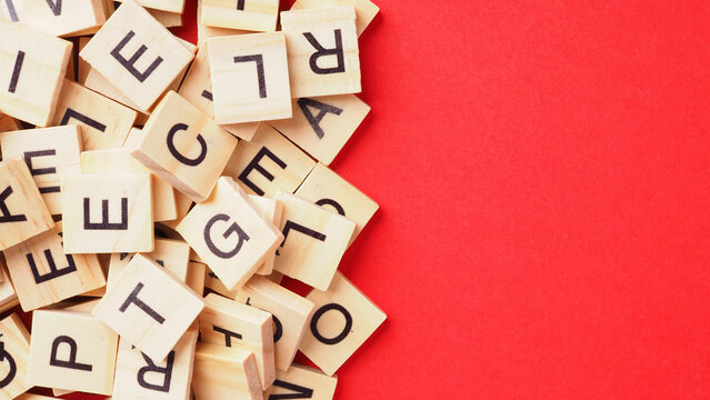 Wooden letter cubes isolated on red background