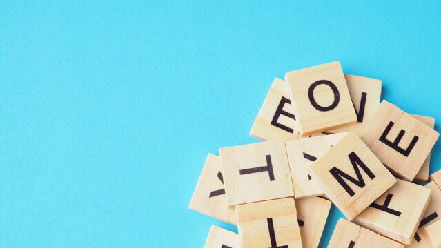 Wooden letter cubes isolated on blue background