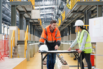 Railway technician engineer checkingthe details of the electric train repair schedule in maintenance plant, Sky train, Transportation and transport for electric train, Teamwork and synergy concept.