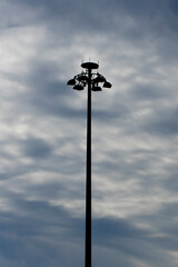 A tall electric lighting pole installed to illuminate a playing field