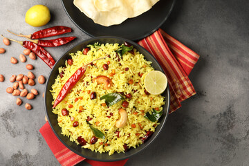 Lemon Rice or fodnicha bhat is South Indian turmeric rice or maharashtrian recipe using rice garnished with nuts curry leaves and lemon juice