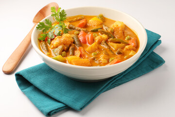 Mix vegetable curry - Indian main course recipe contains Carrots, cauliflower, green peas and beans, baby corn, capsicum
