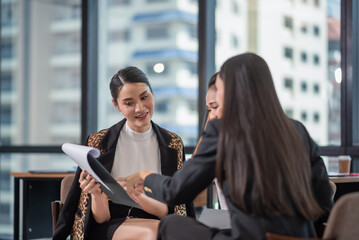 Young Asian Businesspeople working in the office, meeting to discussing business plan, Power of cooperation