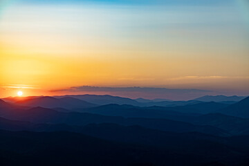 Sunset on the top of the mountain, mountain peaks on the background of the mountain landscape.
