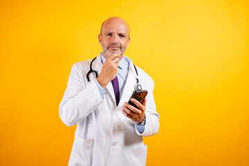 A friendly doctor in a white coat is holding a smartphone, suggesting modern healthcare and communication.
