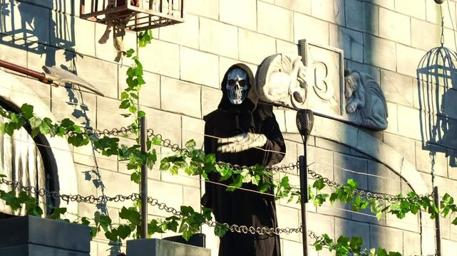 Grim reaper waving, spooky Halloween party costume, day of the dead.