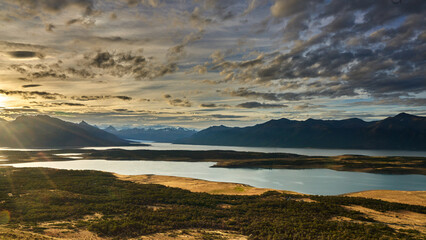 Cerro Cristal, Patagonia, showcasing a vast landscape of snow-capped mountains, tranquil lakes, and lush greenery under a dramatic sky