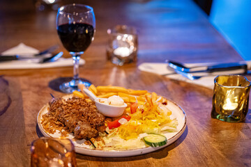 healthy barbecue. Chicken kebab with vegetables and herbs, salad and red wine and candles