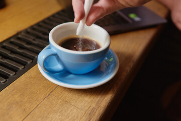 A cup of black coffee with sugar 