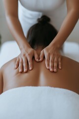 Woman receiving back massage therapy at a spa