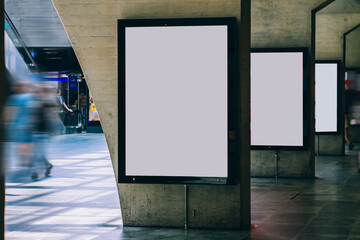 Clear Billboard in public place with blank copy space screen for advertising or promotional poster content, empty mock up Lightbox for information, blank display in station area with daylight