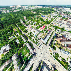 Aerial city view with crossroads and roads, houses, buildings, parks and parking lots, bridges. Helicopter drone shot. Wide Panoramic image.