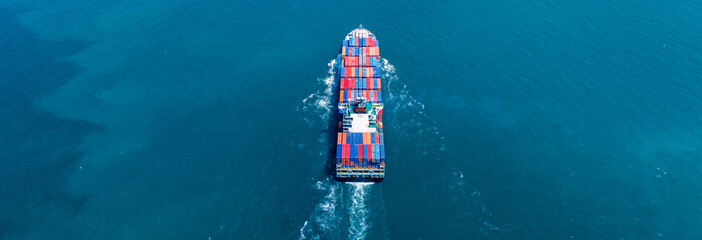 Cargo container ship carrying container and running out international container port customs...