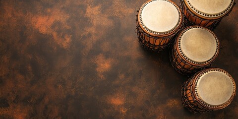 Collection of traditional drums resting on a textured background, perfect for music, culture, and art themes.