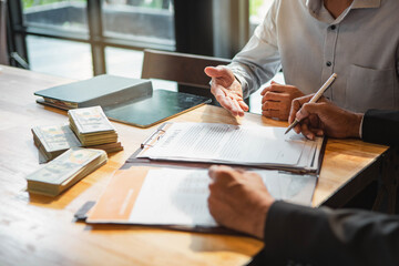 Customer shaking hands after signing contract documents for realty purchase, Bank employees congratulate, Concept mortgage loan approval. Business loan from a bank employee. finance concept .