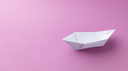 A white paper boat on a pink background.