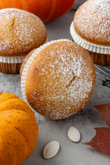 Fresh baked pumpkin cinnamon whole muffin icing sugar powder closeup