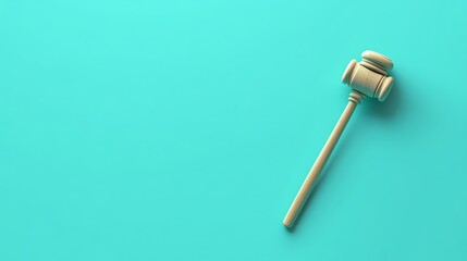 A wooden gavel with a gold band, on a green background.
