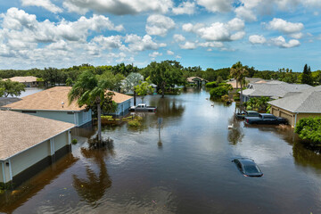 Flooded Florida street with stuck car after hurricane Debby rainfall surrounded with water....