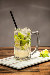 Refreshing Classic Mojito Soda with Lime and Mint served in mug isolated on wooden table side view of cold beverages drink