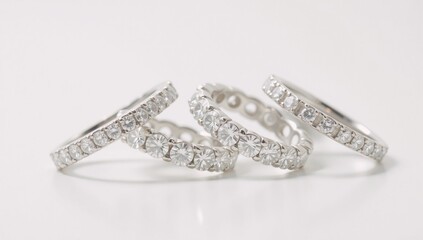 Photorealistic image featuring multiple diamond eternity rings against a white background
