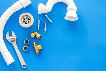 Plumber profession with gear and instruments for repair tubes on blue background top view copyspace