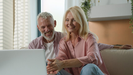 Mature senior middle aged Caucasian couple smiling cheerful woman man laugh together old family...