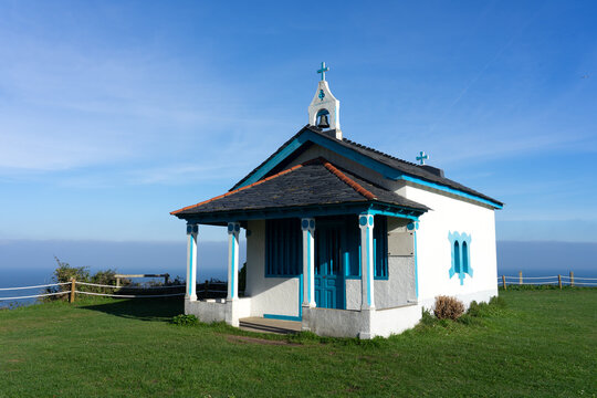Hermitage of the Regalina with the typical Asturian horreos in Cadavedo, Asturias, Spain