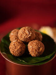 Sesame seeds laddu on the green leaf 
