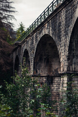 Fototapeta premium Old aqueduct arch over a dried up river in Austria