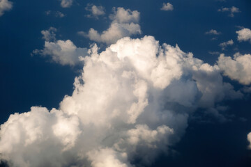 Rain clouds forming at high altitude. View from plane window at high altitude of sky. Air travel concept