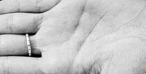 Close-up of a ring on a palm: minimalist black and white photography