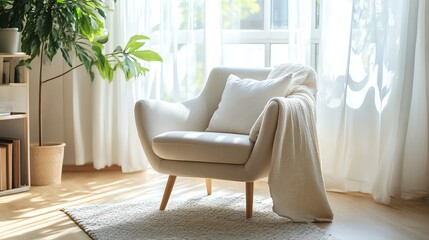 A living room with a white armchair in front of a window.