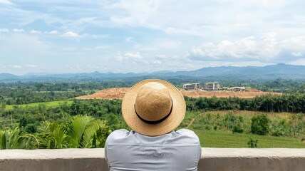A poor farmer watching corporate developers build a luxury resort on land that was once farmland   land inequality, corporate takeover