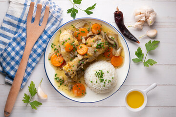 Chicken thigh stew with vegetables and rice.Top view table with  decoration.