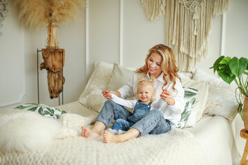 Happy loving family. Mother and her daughter child girl playing and hugging.